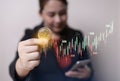 Business woman in hand bitcoin coins and smartphone with crypto trading chart. cryptocurrency exchange