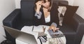 Selective focus of Business woman hand with calculate which she is Confused tired and sitting at her desk with laptop, hands