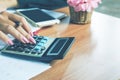Business woman hand calculating her monthly expenses during tax season Royalty Free Stock Photo