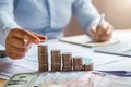 business woman hand holding coins to stack on desk concept saving money finance Royalty Free Stock Photo