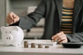 Business woman hand holding coins to stack on desk concept saving money finance and accounting Royalty Free Stock Photo