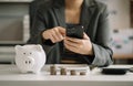 Business woman hand holding coins to stack on desk concept saving money finance and accounting Royalty Free Stock Photo