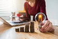 Business woman hand holding lightbulb with coins stack on desk. concept saving energy. Royalty Free Stock Photo