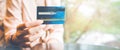 Business woman hand holds a blue credit card to make a purchase.For web banner Royalty Free Stock Photo