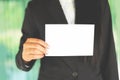 Business woman hand mockup holding blank sheet of paper office working - young woman in suit shows white card Area for advertising