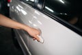 Business woman hand open person white car. Automobile vehicle female owner catching a door handle. Driver, service, lock, Royalty Free Stock Photo