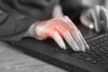Business woman hand pain caused by an excessive use of computer