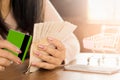 Business woman hand preparing money in hand for payment from credit card form shopping online debt