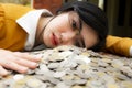 Business woman Hand Protecting With Stacked lots Coin, Portrait of beautiful happy young lady hands Pick up money on wooden table