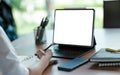 Business woman hand working at a computer and writing on a noteped with a pen in the office Royalty Free Stock Photo