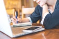 Business woman hand is working on a notebook computer and writin Royalty Free Stock Photo