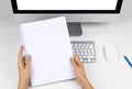 Business woman hands holding notebook with space for text. Business workplace with computer with isolated empty screen Royalty Free Stock Photo