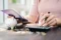 Business woman hands holding saving account passbook with calculator, account and saving concept Royalty Free Stock Photo