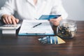 Business woman hands holding saving account passbook with calculator, account and saving concept. Asian woman checking bills, Royalty Free Stock Photo