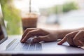 Business woman hands typing on laptop computer keyboard in coffee shop close up Royalty Free Stock Photo