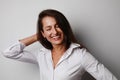 Portrait of young business woman with happy face posing isolated over grey wall background. Space for text. Royalty Free Stock Photo