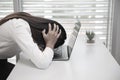 Business Woman Having Headache While Working Using Laptop Computer. Stressed And Depressed Girl Touching Her Head, Feeling Pain Royalty Free Stock Photo