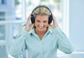 Business woman, headphone and listening to music, podcast and streaming on break in the office with happy smile. Female Royalty Free Stock Photo