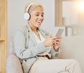 Business woman, headphones and phone streaming of music or video in a office with technology. Black woman smile on