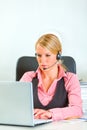 Business woman with headset working on laptop Royalty Free Stock Photo