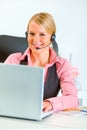 Business woman with headset working on laptop Royalty Free Stock Photo