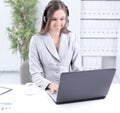 Business woman with headset working on laptop. Royalty Free Stock Photo