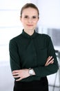 Business woman headshot in modern office. Secretary or female lawyer standing straight and looking at camera. Business Royalty Free Stock Photo