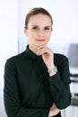 Business woman headshot in modern office. Secretary or female lawyer standing straight and looking at camera. Business Royalty Free Stock Photo