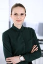 Business woman headshot in modern office. Secretary or female lawyer standing straight and looking at camera. Business Royalty Free Stock Photo