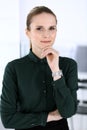 Business woman headshot in modern office. Secretary or female lawyer standing straight and looking at camera. Business Royalty Free Stock Photo