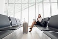 Business woman on her smart phone waiting at the airport Royalty Free Stock Photo