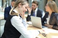 Business woman with her staff, people group in background at modern bright office indoors Royalty Free Stock Photo