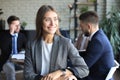 Business woman with her staff, people group in background at modern bright office indoors Royalty Free Stock Photo