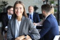 Business woman with her staff, people group in background at modern bright office indoors Royalty Free Stock Photo