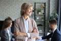 Business woman with her staff, people group in background at modern bright office indoors Royalty Free Stock Photo