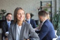 Business woman with her staff, people group in background at modern bright office indoors Royalty Free Stock Photo