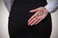 Business woman hiding behind her back a palm with an inscription me too. Stop sexual harassment against women. metoo concept