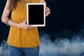 Business woman hold computer tablet with smoke in background Royalty Free Stock Photo