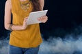 Business woman hold computer tablet with smoke in background Royalty Free Stock Photo