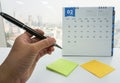 Business woman hold pen for meeting reminder on February calendar Royalty Free Stock Photo