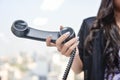 Business woman is holding the black IP Phone handset Royalty Free Stock Photo