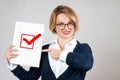 Business woman holding blank paper with check Royalty Free Stock Photo