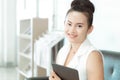 Business woman holding digital tablet with smiling and looking at camera for ready work in office Royalty Free Stock Photo