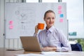 business woman holding and enjoy coffee cup sitting at working place on White board background