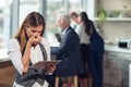 Business woman holding files. Looking at files. Worried. Royalty Free Stock Photo