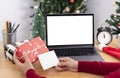 Business woman holding giftbox and greeting card on office table in Christmas day Royalty Free Stock Photo