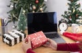 Business woman holding giftbox on office table in Christmas day Royalty Free Stock Photo