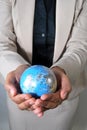 Business woman holding globe in her hands Royalty Free Stock Photo