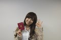 Business woman holding Japanese passport with OK sign