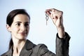 Business woman holding key between fingers